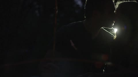 A couple is kissing at night