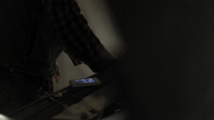 Man working under the hood of a vehicle