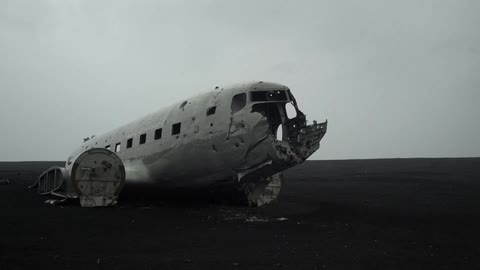 An old, dilapidated plane sits in the middle of nowhere