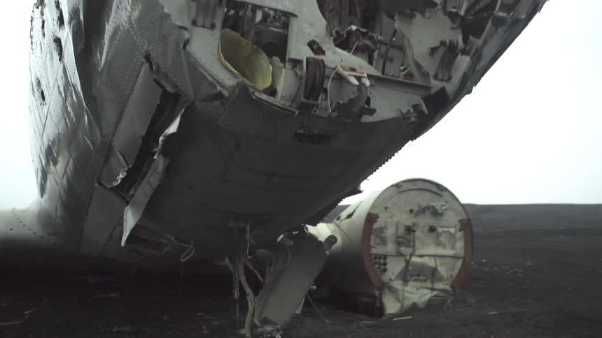 Man walking around the wreckage of a jetliner