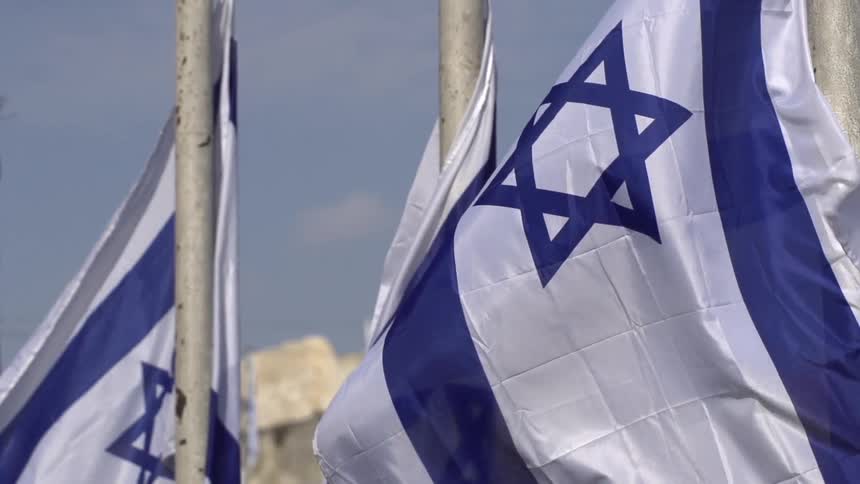 Three israeli flags hoisted on poles