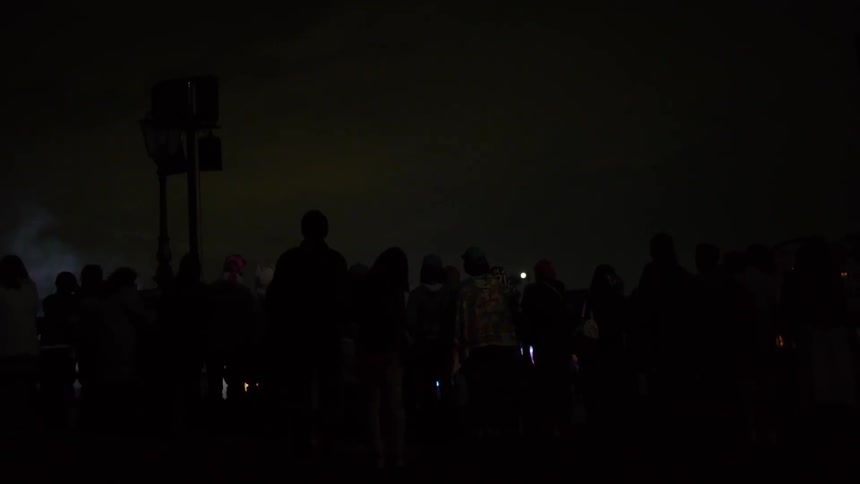 A group of people watching a fireworks show