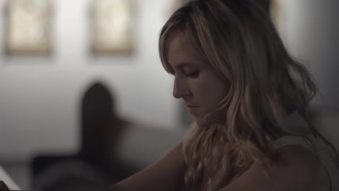 A woman sits in a church alone