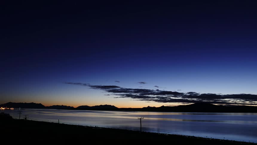 Clouds float over a lake at sunset