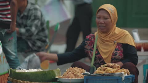 A woman sells food on the street