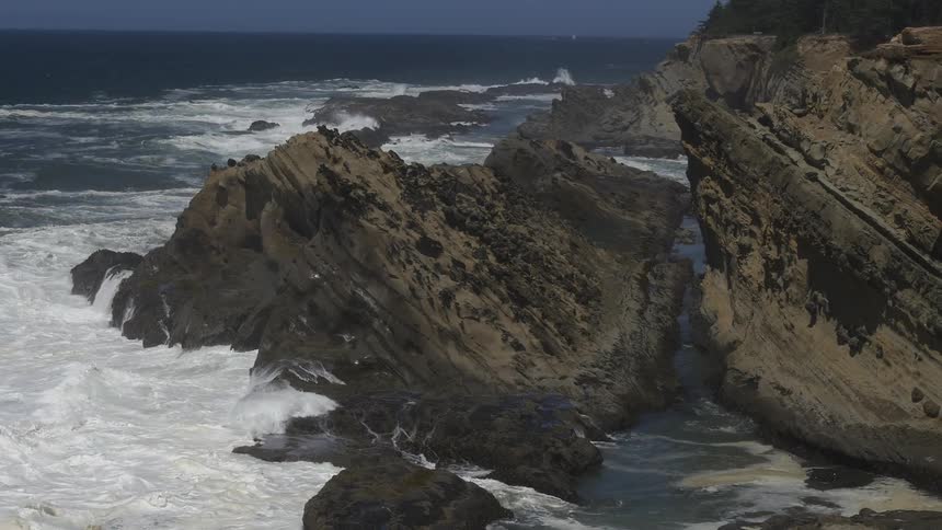 Ocean waters crashing the rocks and cliffs on the shore