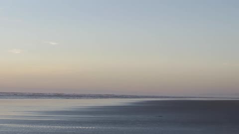 A scenery of calming sea at dawn