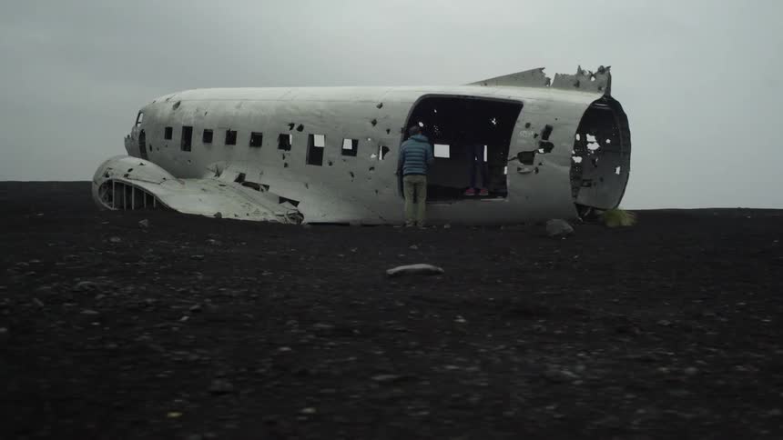 A person investigating an abandoned plane