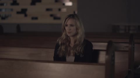 Woman sitting in a church pew