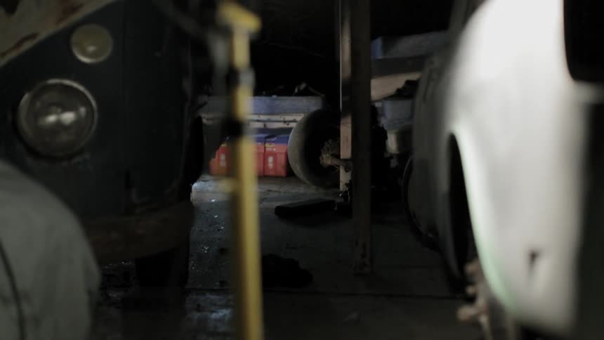A garage filled with cars and parts