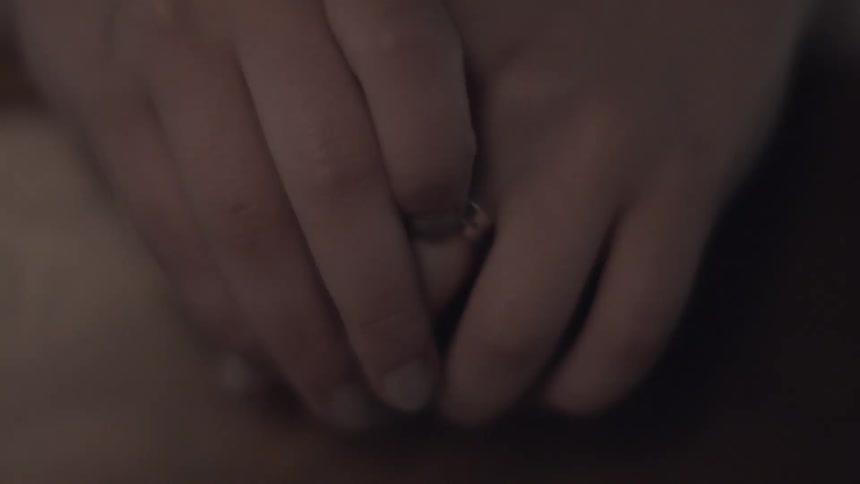 A person moves a ring on their finger