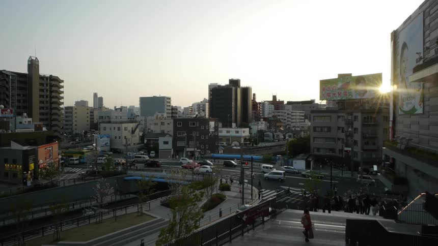 Cars driving on a busy city street as the sun sets