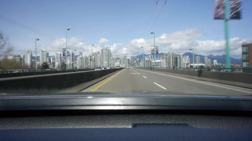 Driving on a highway towards a city