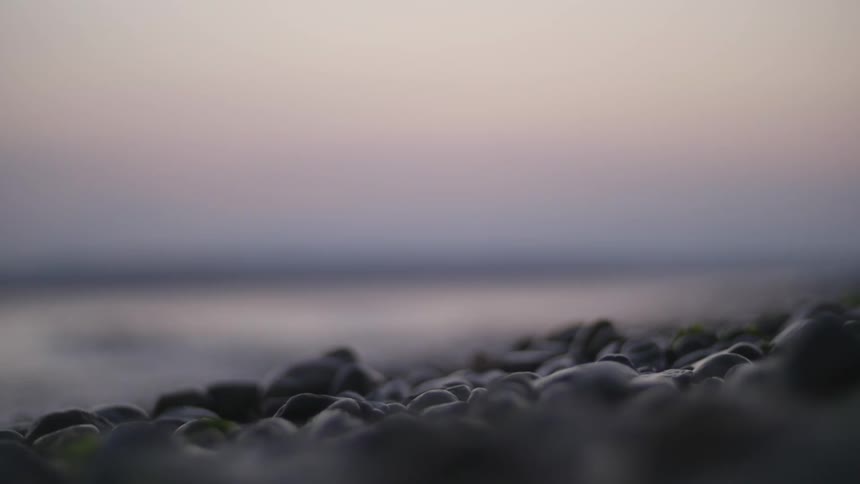 Rocks on a beach next to water