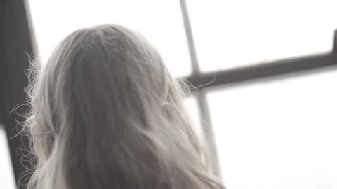 A woman wipes a paned window