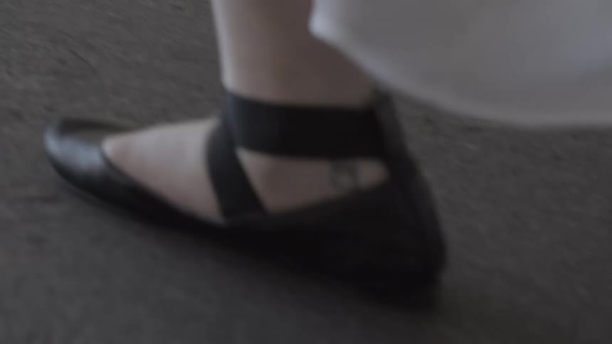 Woman walking wearing ballet slippers