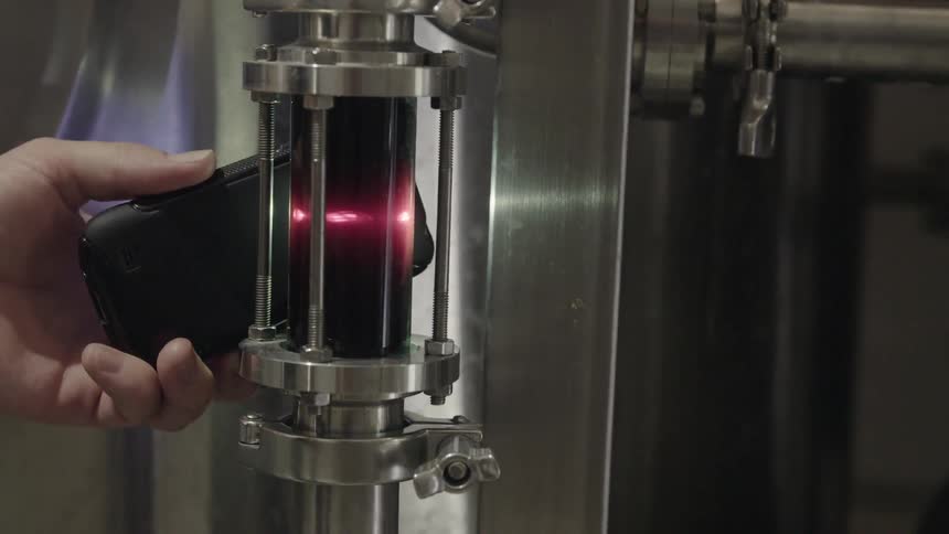 A hand holds up a piece of equipment