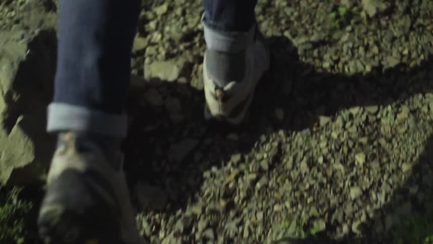A person walking on top of gravel