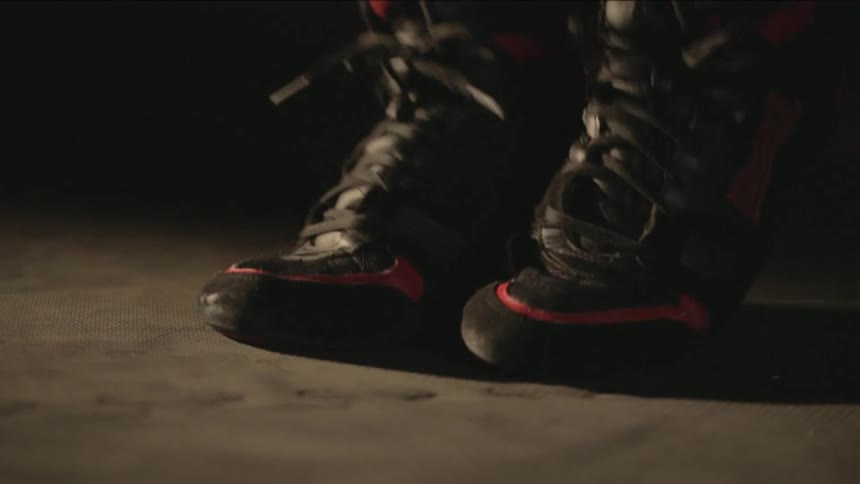 An athlete wearing sports shoes is skipping indoors