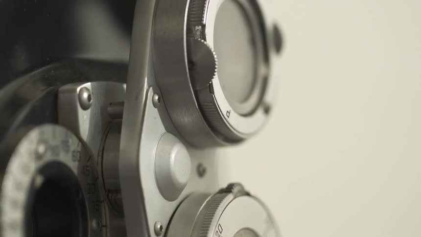Person adjusting a lens on a phoropter machine