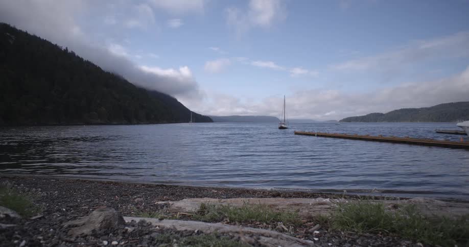 Lake water laps onto a pebbly beach
