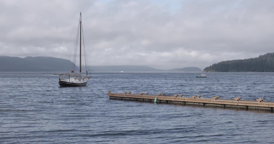 A sailboat on a lake on a cloudy day