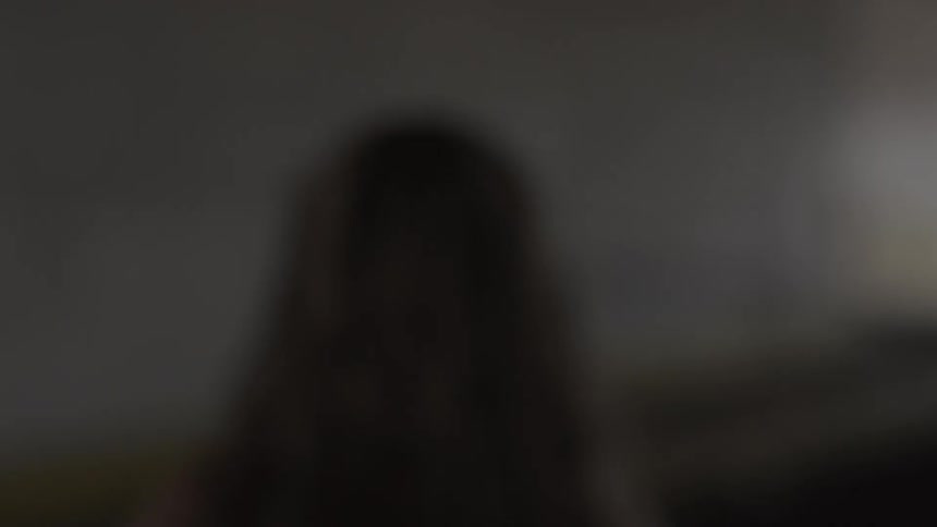Woman walking quickly across a basement