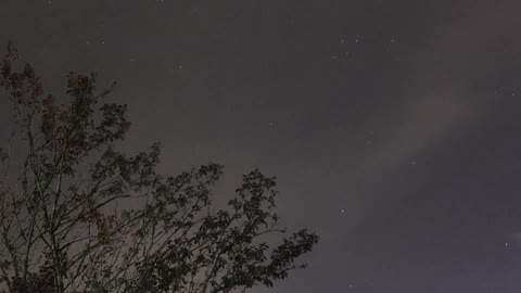 Clouds passing over a starry sky