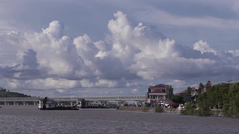 A view of a body of water with a bridge in the distance, and part of the town shoreline
