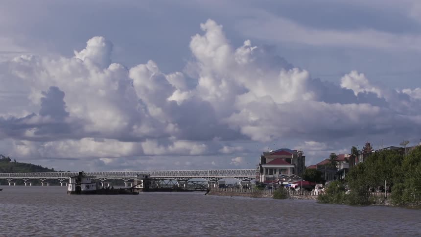 A view of a body of water with a bridge in the distance, and part of the town shoreline