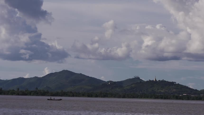 A scenery of a mountain and a boat in a lake