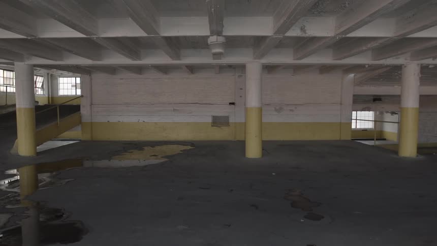A woman runs through a parking garage