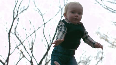 A child is flung into the air while playing