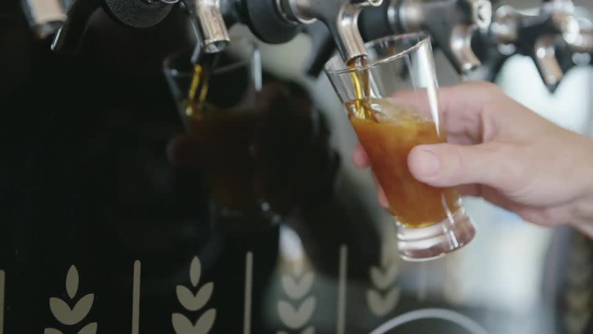 A person pouring a beer
