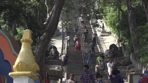 Crowd of people walking up a large outdoor staircase