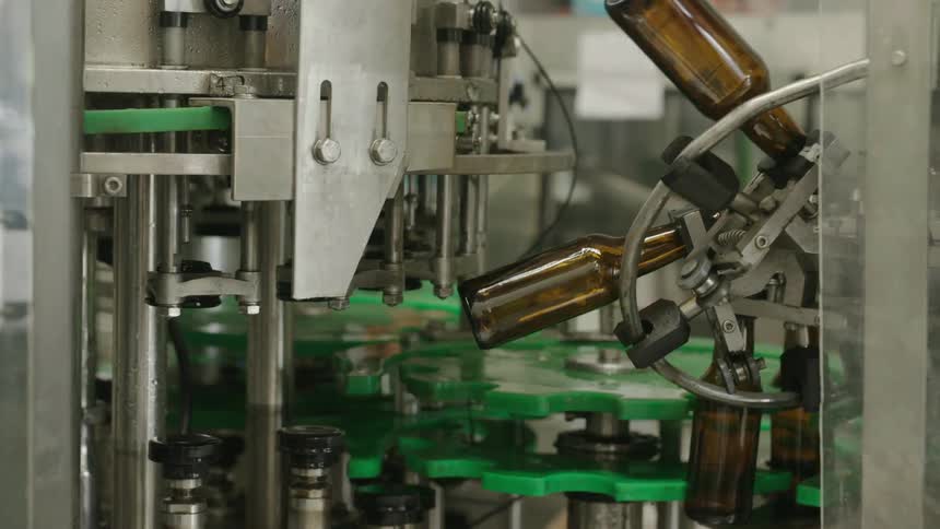 Machinery in a bottle manufacturing plant moves slowly