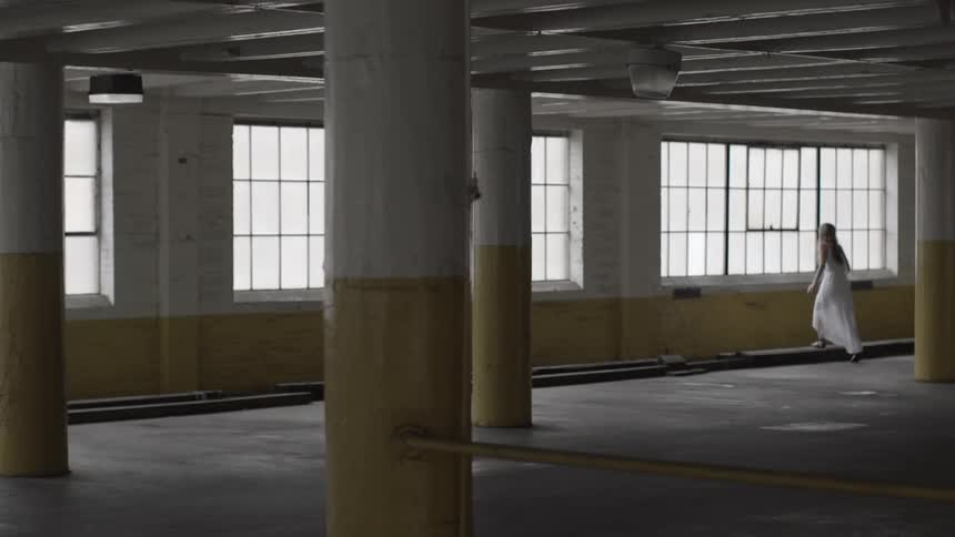 A woman walking inside of a building
