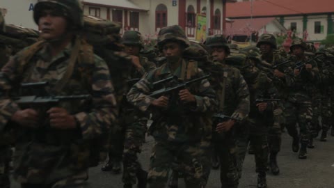 Large group of army men marching and carrying guns