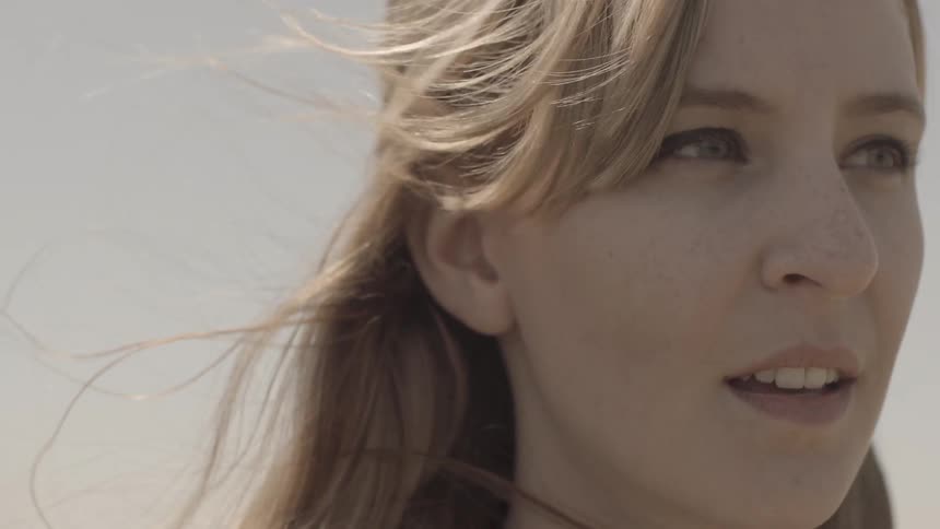 A close up shot of a woman looking contemplative