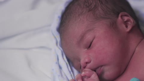 A newborn baby laying down