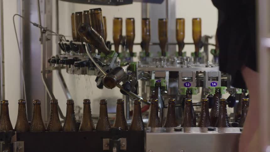 Brown glass bottles on a conveyor belt