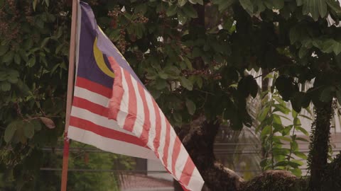 The malaysian flag flapping in the breeze