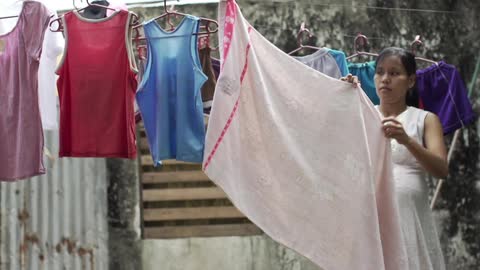 Woman hanging clothes on a line
