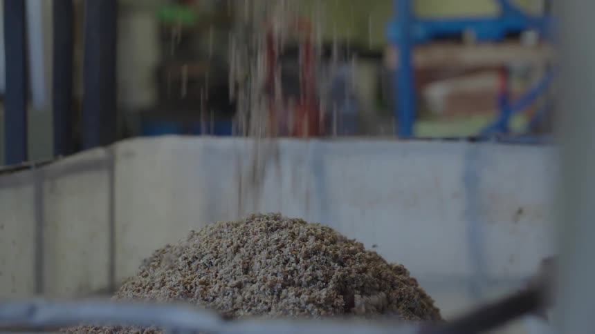 A food being dropped to a container from a machine at the factory