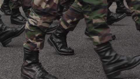 People in fatigues marching