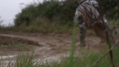 A person rides a dirt bike through mud