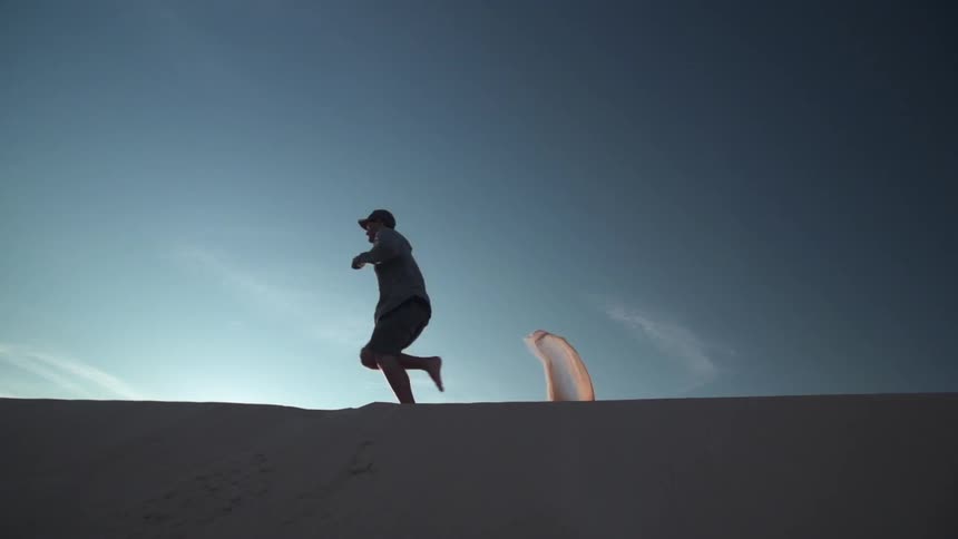 Man running on sand dune