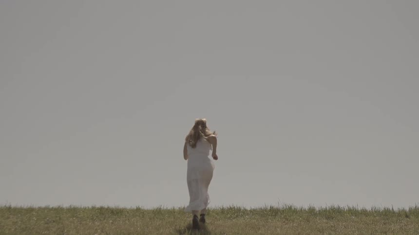 A person running in the grass