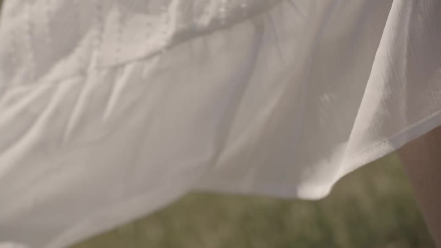 A white dress billows in the breeze