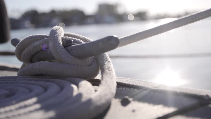 Rope is coiled on the deck of a sailing boat